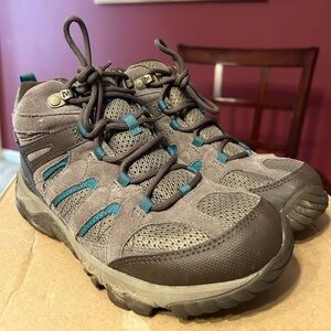 Merrell hiking boots/sneakers in brown/neutral tones with some blue accents.